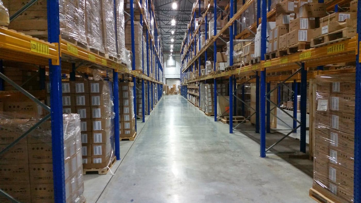 Industrial warehouse aisle with packed boxes and pallet racks
